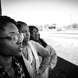 Black women looking out. Black History Month is a chance for Black people in the UK to celebrate Black identity, heritage, culture and experiences openly.